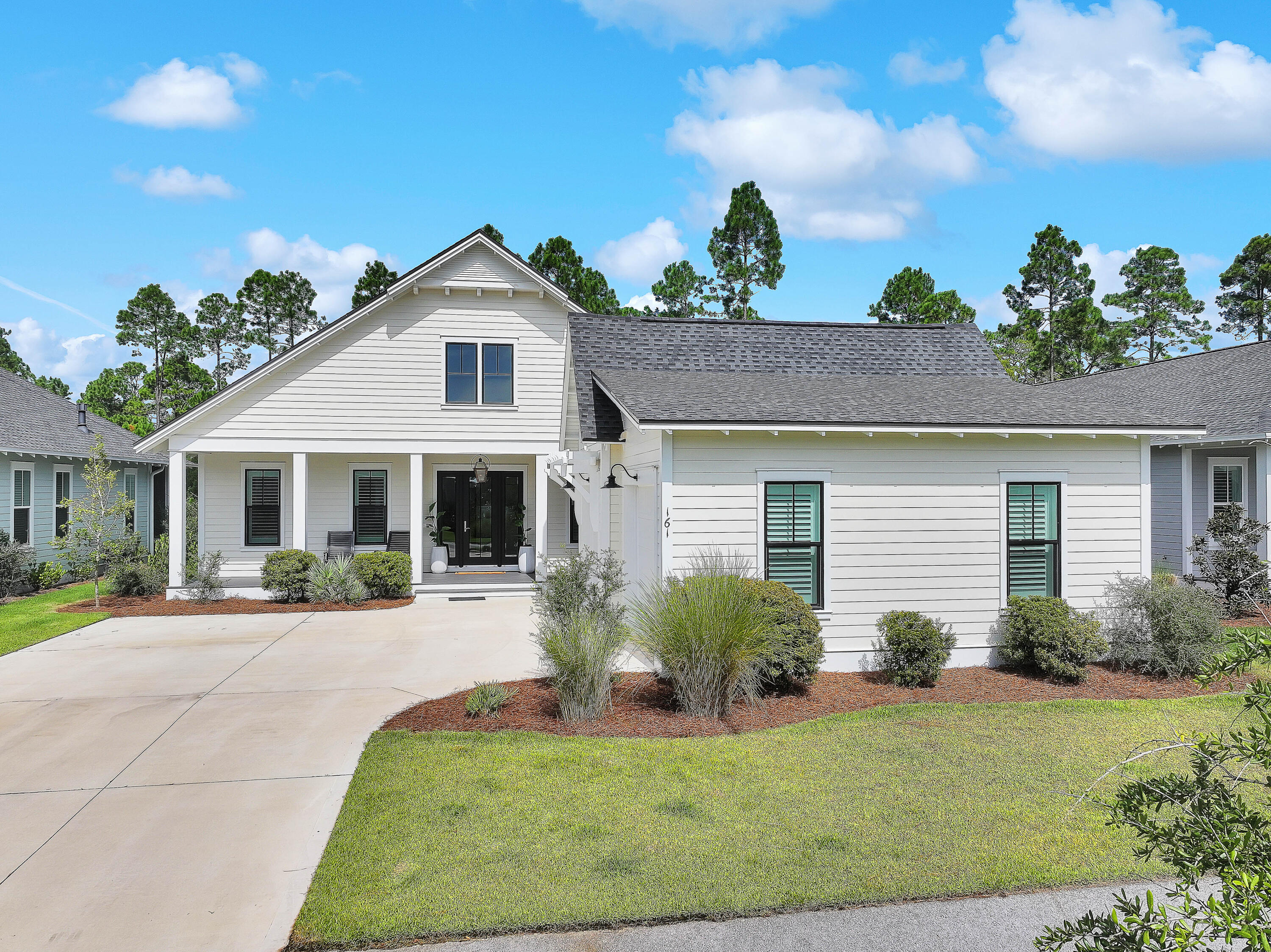 161 Sidecamp Rd Inlet Beach Inlet Beach, FL 32461 - Photo 56 of 66 a front view of a house with a yard and potted plants