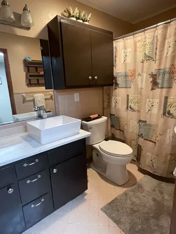 a bathroom with a toilet sink and mirror