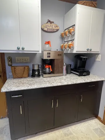 a living room with patio furniture and a floor to ceiling window