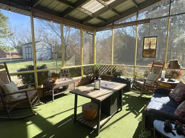 a view of a backyard with wooden fence