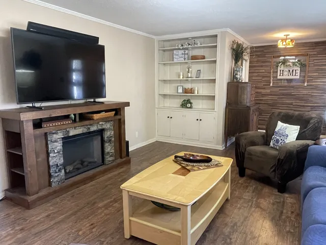 a living room with a flat screen tv and a fireplace