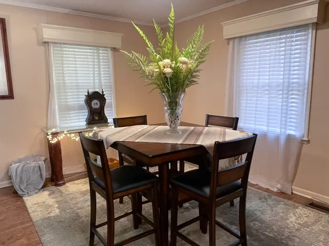 a view of a dining room with furniture and window