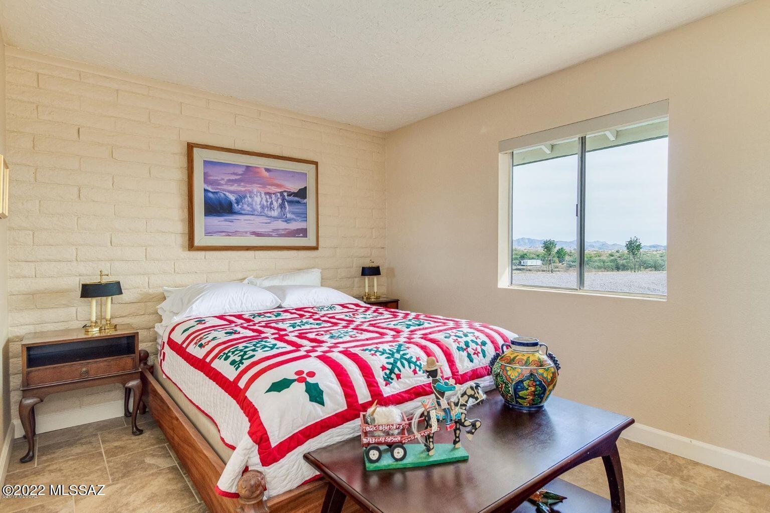 36645 South Arivaca Ranch Road Arivaca, AZ 85601 - Photo 25 of 49 a bedroom with a bed a wall painting and a window