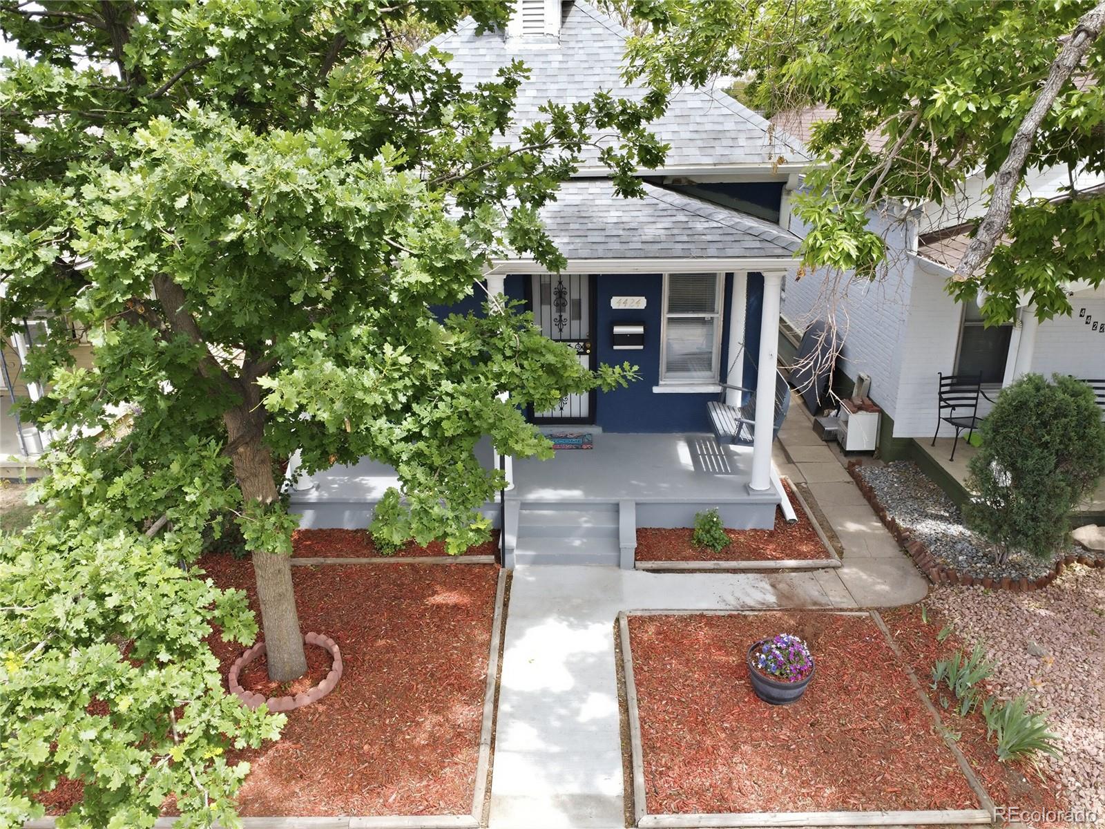 4424 Sherman Street Denver, CO 80216 - Photo 15 of 16 a front view of a house with garden