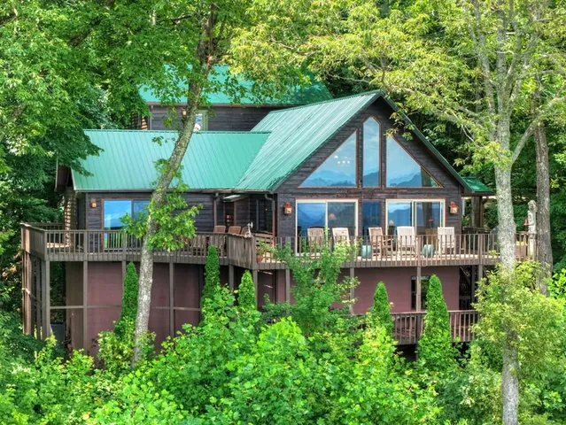 a front view of a house with balcony and garden