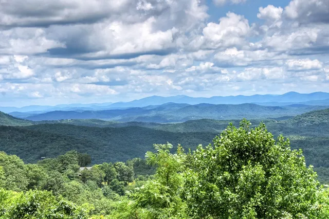 a kitchen with kitchen island granite countertop a sink and a refrigerator