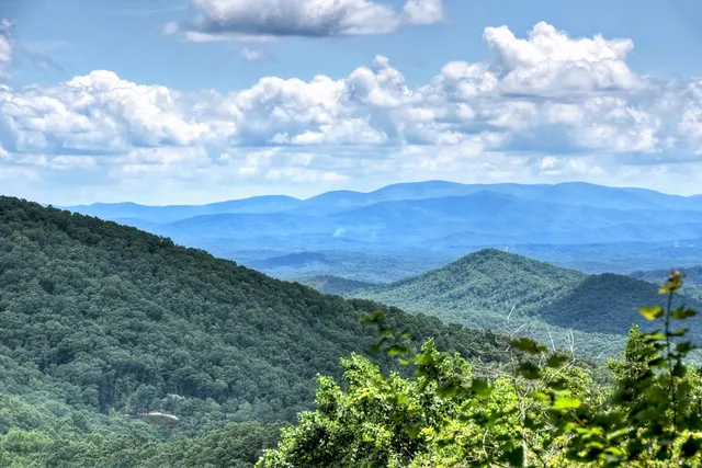 a kitchen with stainless steel appliances granite countertop sink stove and wooden cabinets