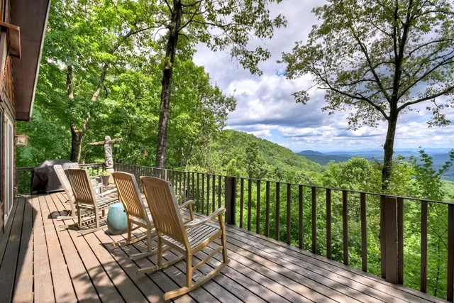 a view of a house with yard and sitting area