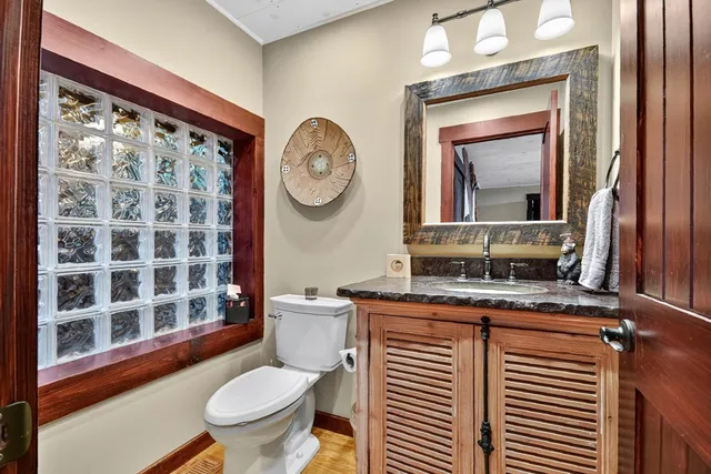 a view of a house with a yard and potted plants