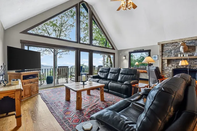 a dining room with wooden floor a chandelier a wooden table and chairs