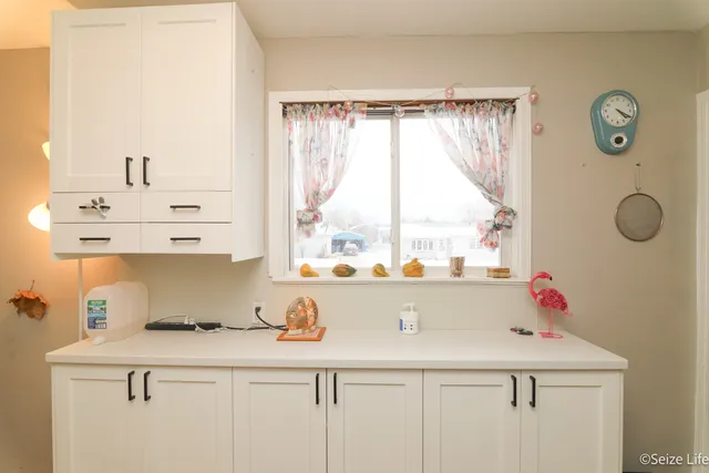 a kitchen with a sink a window and cabinets