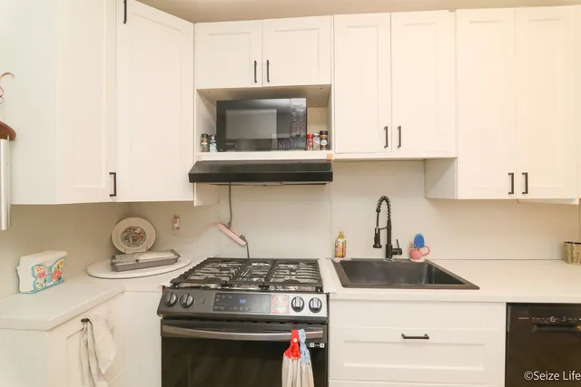 a kitchen with a stove and cabinets
