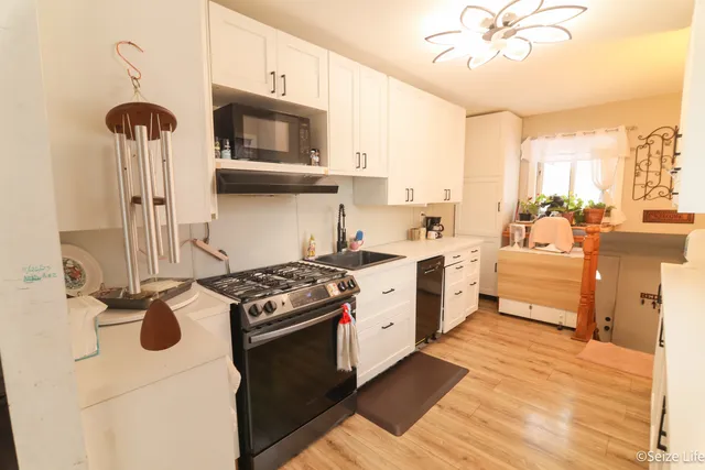 a open kitchen with stainless steel appliances kitchen island granite countertop a stove and a sink