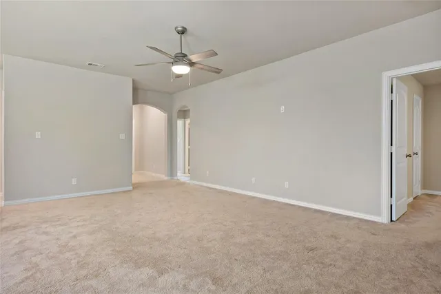 a view of an empty room with a fan