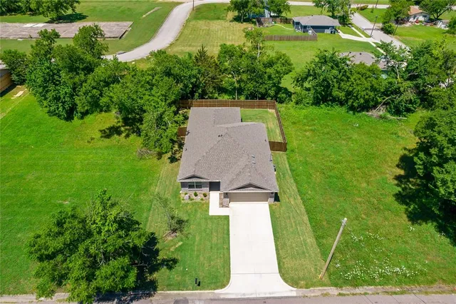 an aerial view of a house with a yard