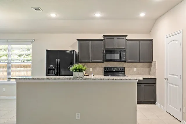 a kitchen with stainless steel appliances a sink and a refrigerator