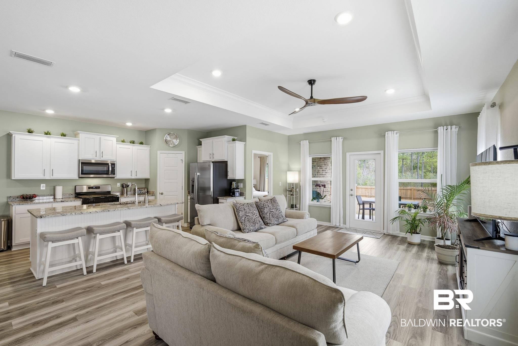 13887 Antler Hl Road Daphne, AL 36527 - Photo 9 of 50 Living room featuring ceiling fan, light wood finished floors, recessed lighting, ornamental molding, and a tray ceiling