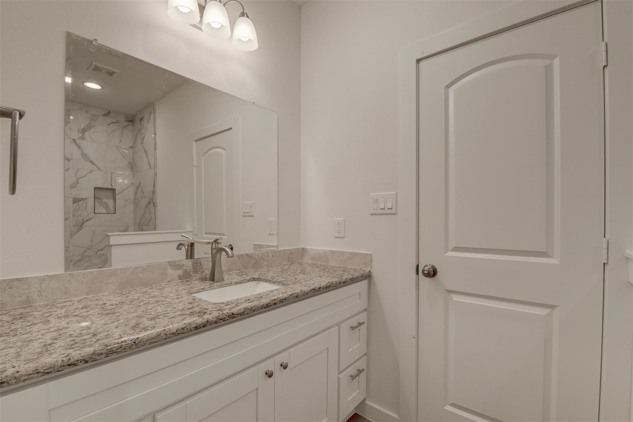 8410 Sandra Street Houston, TX 77016 - Photo 12 of 23 a bathroom with a granite countertop sink and a mirror