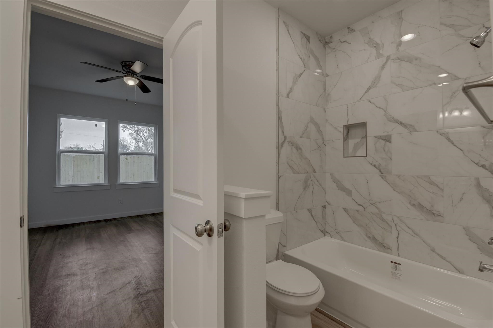8410 Sandra Street Houston, TX 77016 - Photo 13 of 23 a bathroom with a toilet a sink and bathtub
