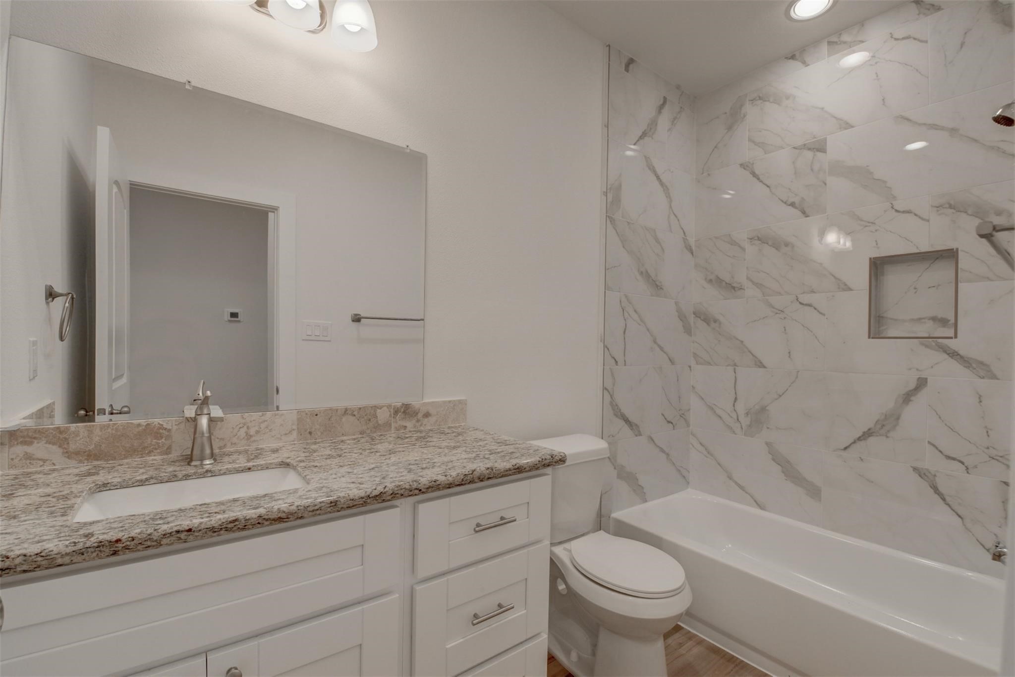 8410 Sandra Street Houston, TX 77016 - Photo 17 of 23 a bathroom with a granite countertop sink a toilet and bathtub