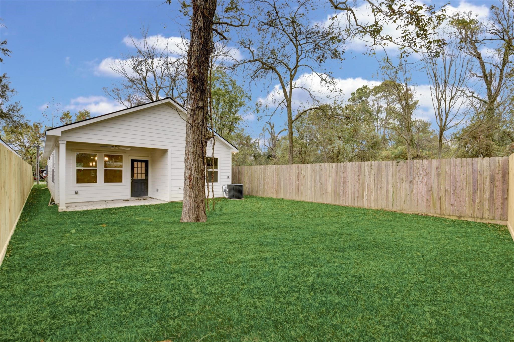 8410 Sandra Street Houston, TX 77016 - Photo 22 of 23 a yellow house with garden in front of it