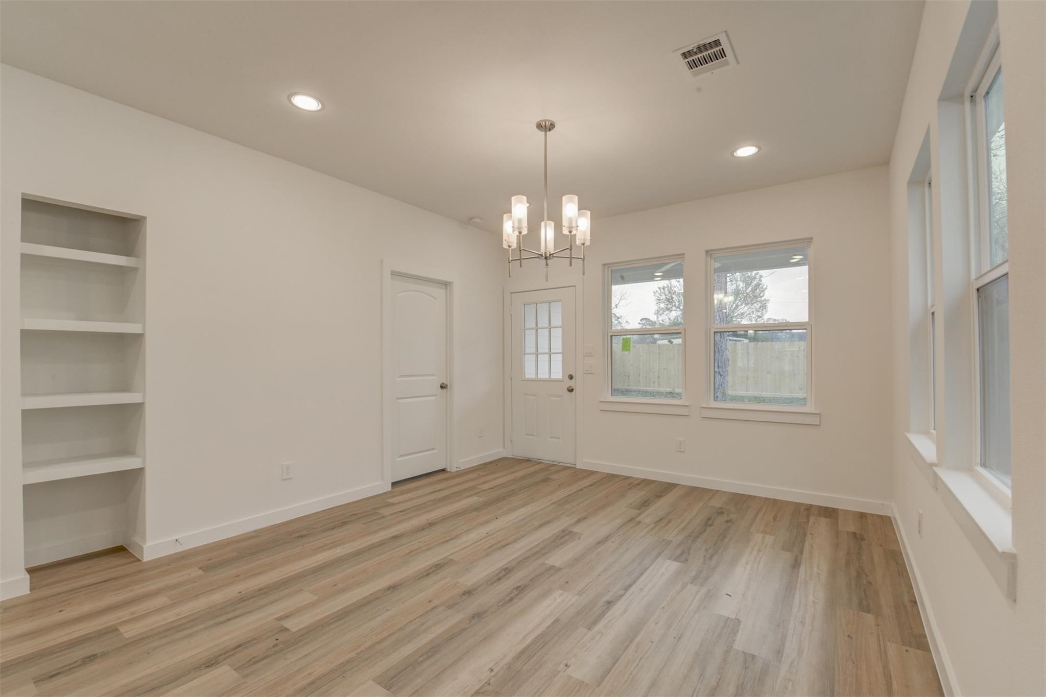 8410 Sandra Street Houston, TX 77016 - Photo 9 of 23 wooden floor in an empty room with a window