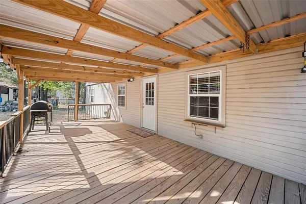 a view of a balcony with wooden floor