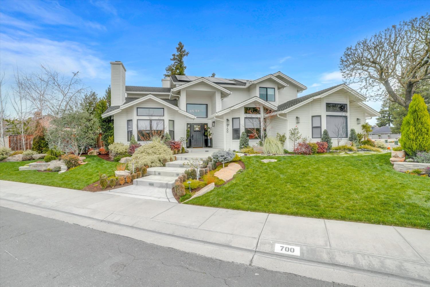 a front view of a house with a garden and fire pit