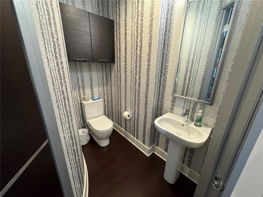 239 Cosmopolitan Court Sarasota, FL 34236 - Photo 15 of 29 a bathroom with a toilet sink and mirror