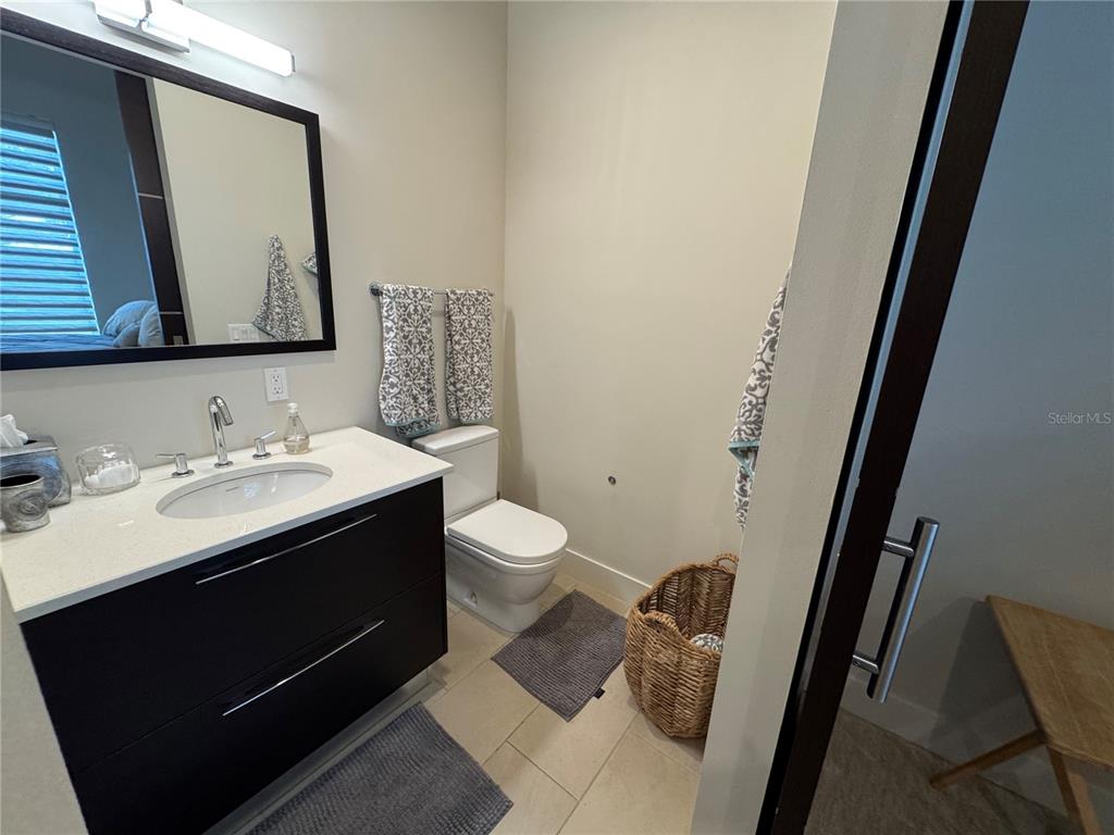 239 Cosmopolitan Court Sarasota, FL 34236 - Photo 23 of 29 a bathroom with a sink vanity granite and toilet
