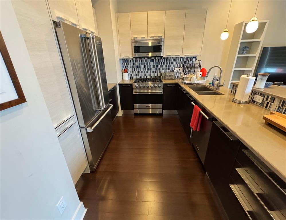 239 Cosmopolitan Court Sarasota, FL 34236 - Photo 8 of 29 a kitchen with stainless steel appliances a refrigerator a sink a stove and cabinets