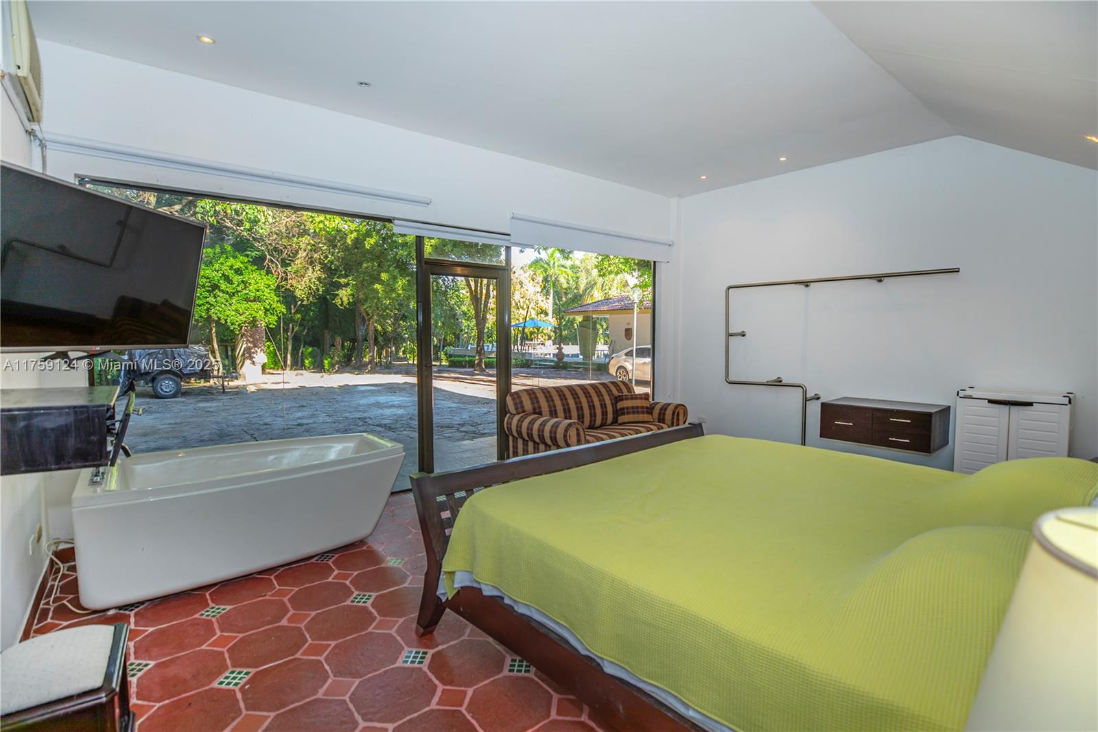 9 Via Girardot Tocaima undefined, CU 00000 - Photo 15 of 23 a bedroom with a bed and a flat tv screen next to a large window