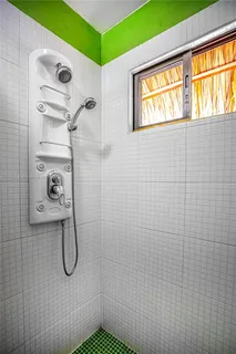 a bathroom with a toilet and a mirror