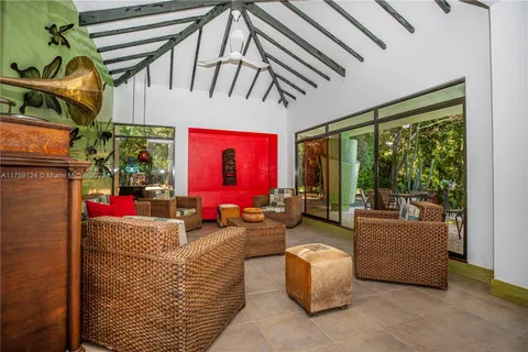 a view of a chairs and table in the backyard