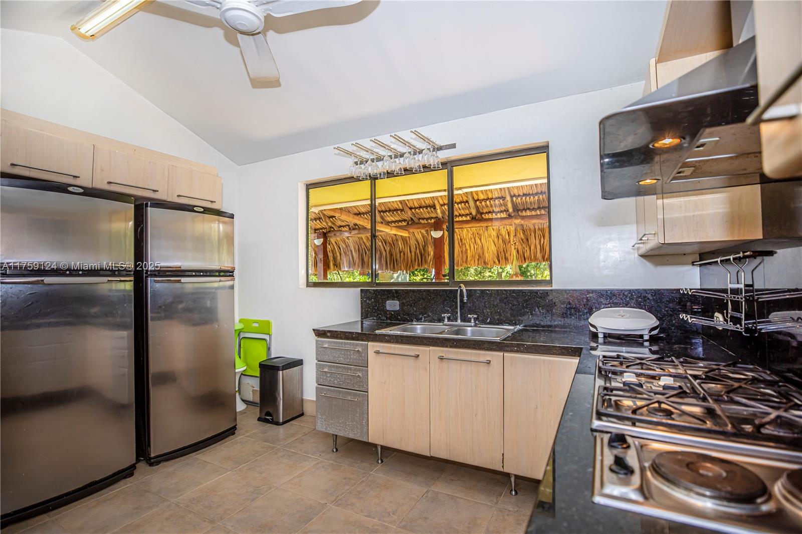 9 Via Girardot Tocaima undefined, CU 00000 - Photo 10 of 23 a kitchen with stainless steel appliances a stove a sink and a refrigerator