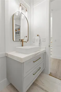 a large white kitchen with a large window