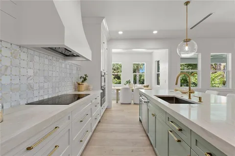 a living room with furniture and a view of kitchen