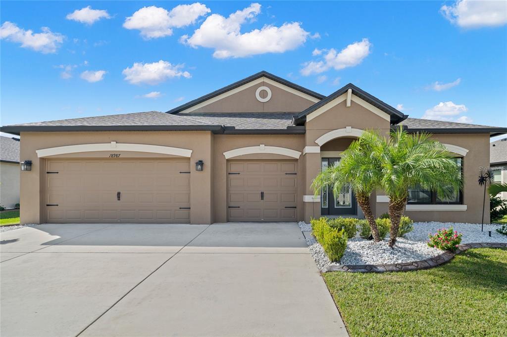 18987 Malinche Loop Spring Hill, FL 34610 - Photo 1 of 1 a front view of a house with a yard