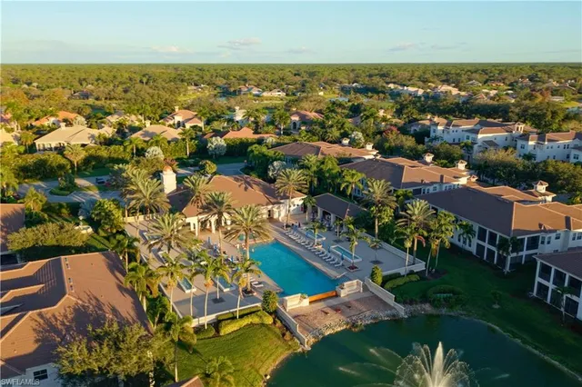 an aerial view of residential houses with outdoor space and trees