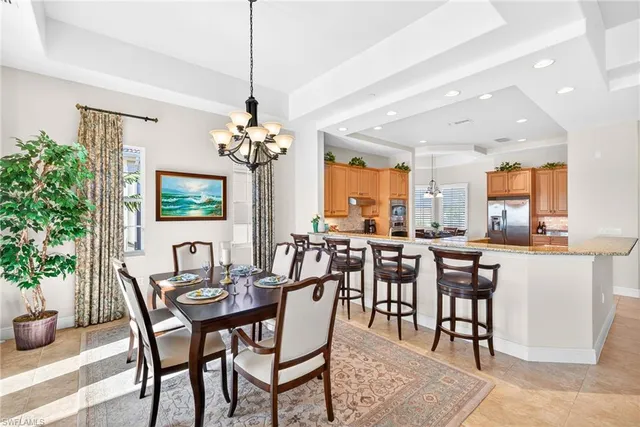 a view of a dining room with furniture and chandelier