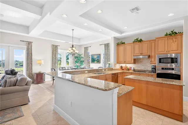 a large kitchen with granite countertop a large window and a counter space