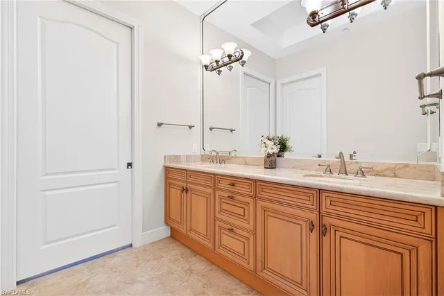 a bathroom with double sink and a mirror