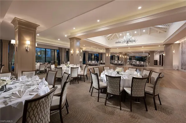 a dining room with stainless steel appliances kitchen island a table and chairs