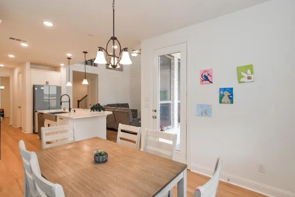 a large kitchen with a table and chairs