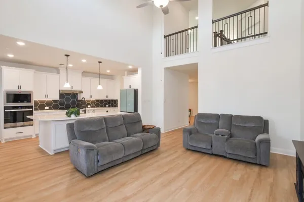 a living room with furniture and kitchen view