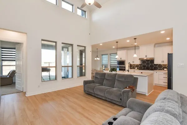 a living room with furniture and a large window