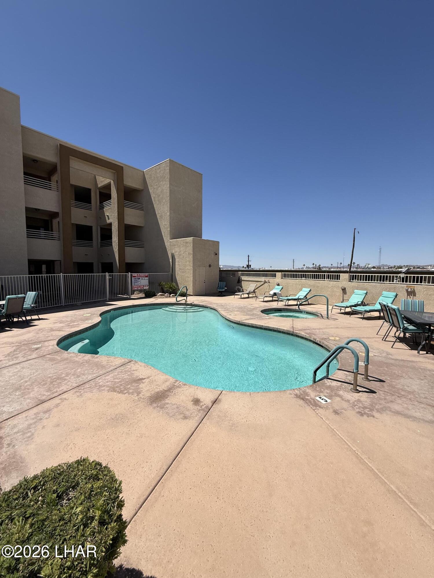 433 London Bridge Road, Unit B101 Lake Havasu City, AZ 86403 - Photo 3 of 35 a view of a house with a yard and sitting area