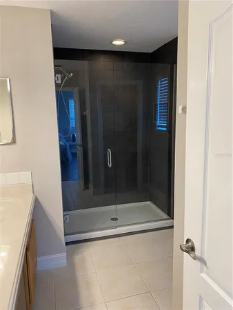 a bathroom with a shower and a sink