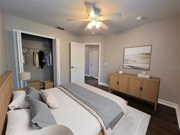 a bedroom with a large bed and a chandelier