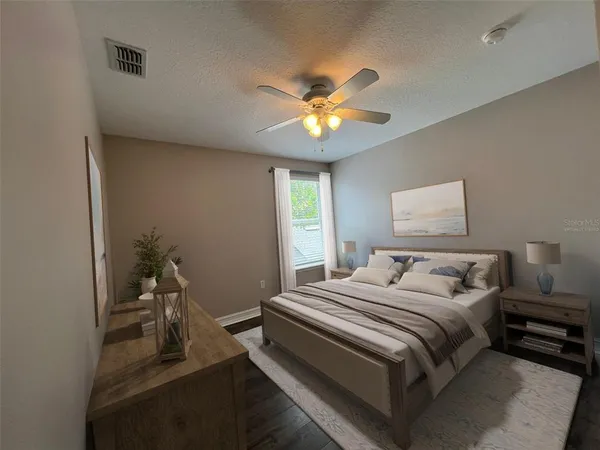 a bedroom with a bed and a chandelier